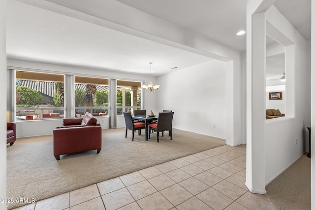 carpeted dining area with a notable chandelier