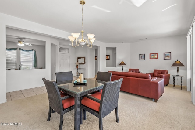 dining space featuring a chandelier and light carpet