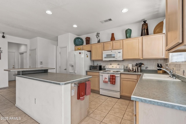 kitchen featuring a kitchen island, sink, light tile patterned floors, light brown cabinets, and white appliances