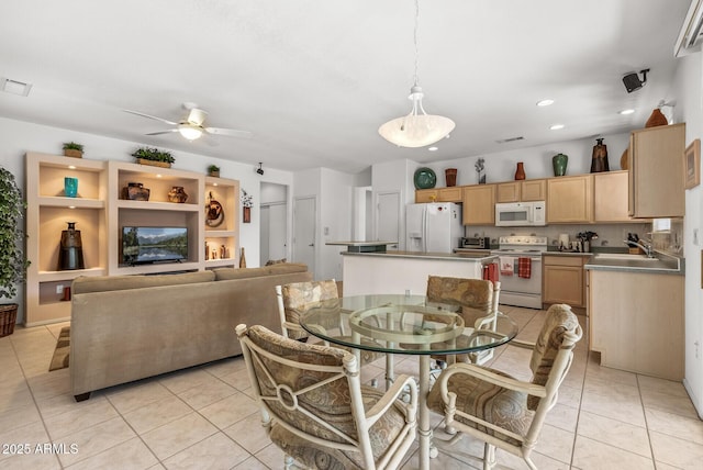 tiled dining space featuring sink and ceiling fan