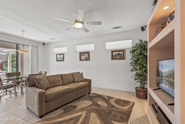 living room with light tile patterned floors and ceiling fan