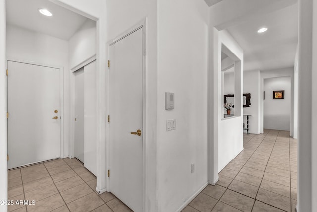 corridor with light tile patterned flooring