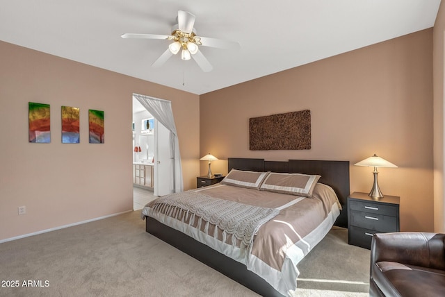 carpeted bedroom with ceiling fan and ensuite bath