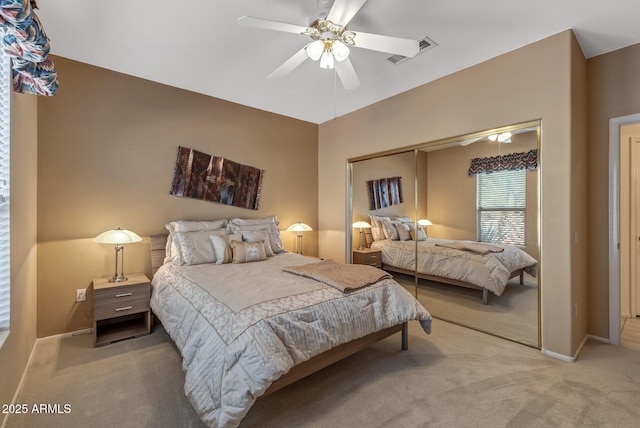 bedroom with ceiling fan, carpet, and a closet