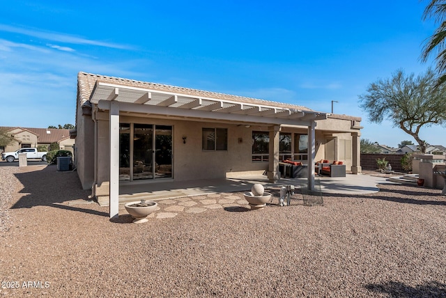 rear view of house featuring a patio and a pergola