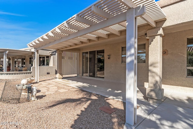 rear view of property featuring a pergola and a patio