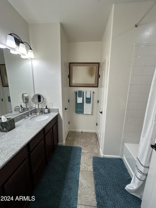 bathroom featuring vanity and shower / bathtub combination with curtain