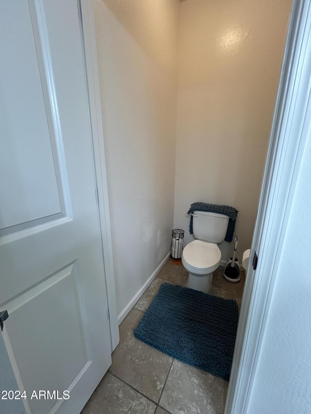 bathroom featuring tile patterned flooring and toilet