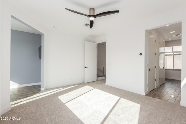 unfurnished bedroom featuring ceiling fan and light carpet