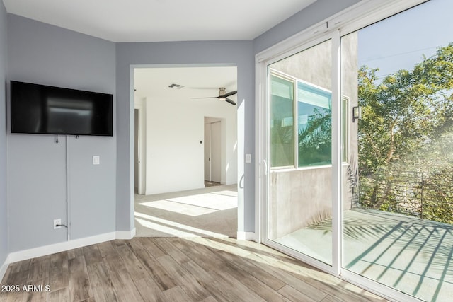 doorway to outside featuring light wood-type flooring, ceiling fan, and a healthy amount of sunlight