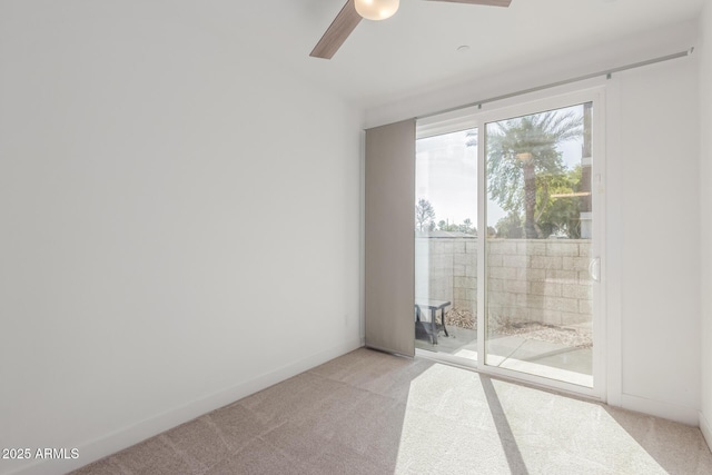 carpeted spare room with ceiling fan