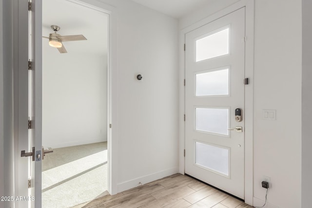 doorway with ceiling fan