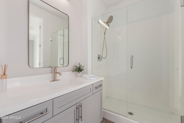 bathroom with walk in shower and vanity