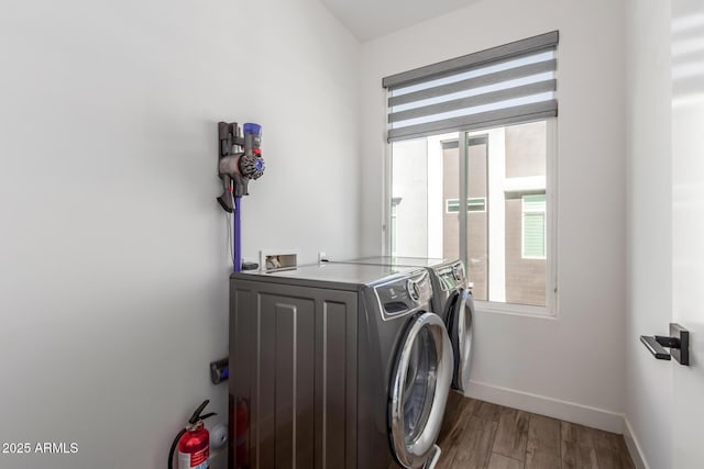 washroom with washer and dryer and hardwood / wood-style flooring