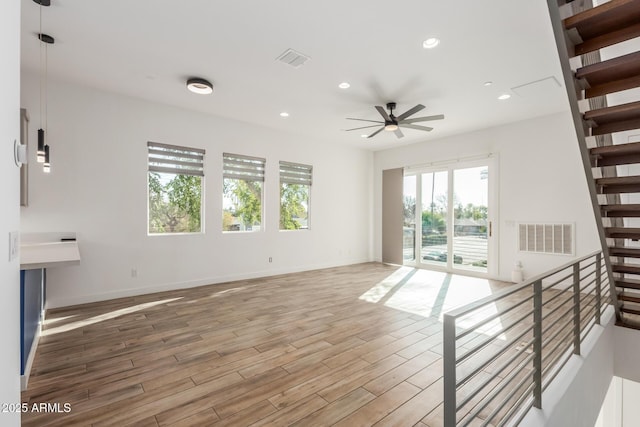 unfurnished living room featuring ceiling fan