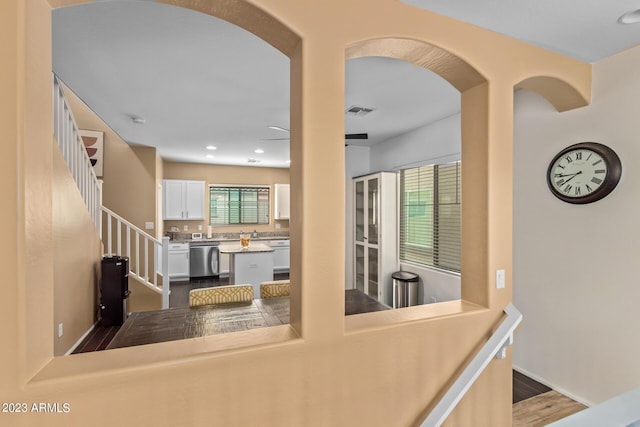 2031 N 77th Ln, Phoenix, AZ 85035 - hallway with arched walkways, dark wood-style flooring, recessed lighting, and stairway