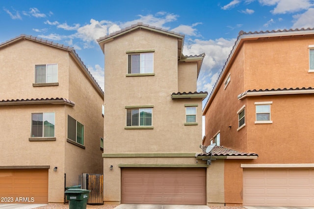 2031 N 77th Ln, Phoenix, AZ 85035 - view of front of property featuring stucco siding, a tile roof, and a garage