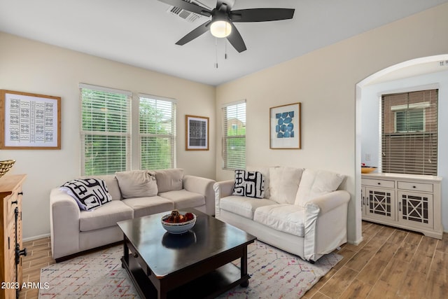 2031 N 77th Ln, Phoenix, AZ 85035 - living room with wood finished floors, a ceiling fan, arched walkways, and baseboards
