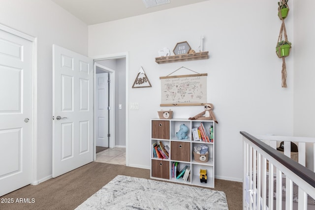 carpeted bedroom with a nursery area