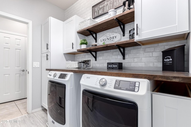 laundry area featuring cabinets and washing machine and dryer