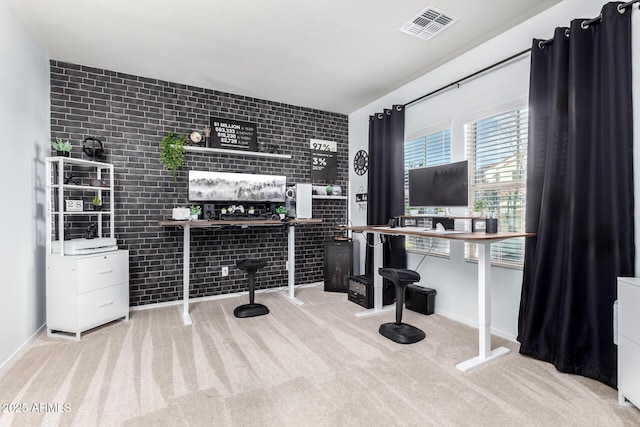 home office featuring light colored carpet and brick wall