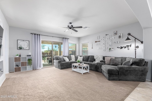 living room featuring light tile patterned floors and ceiling fan