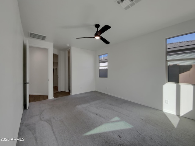 unfurnished bedroom featuring visible vents, baseboards, carpet, and ceiling fan