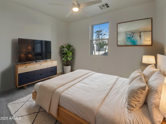 bedroom featuring visible vents, light colored carpet, and ceiling fan