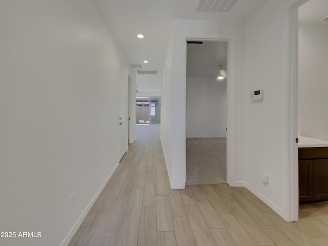 hallway with recessed lighting, visible vents, baseboards, and wood tiled floor