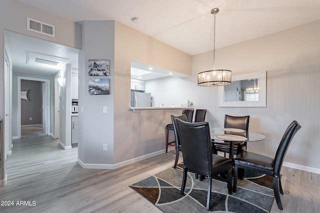 dining area featuring light wood-type flooring