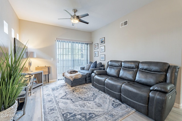 living room featuring ceiling fan and light hardwood / wood-style flooring