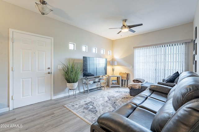 living room featuring light wood-type flooring and ceiling fan