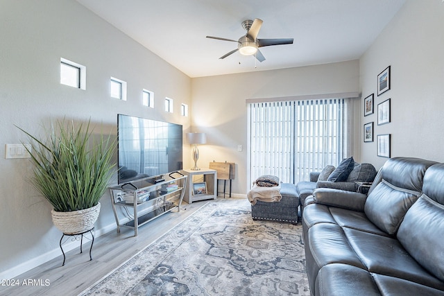 living room featuring hardwood / wood-style flooring, ceiling fan, and a wealth of natural light