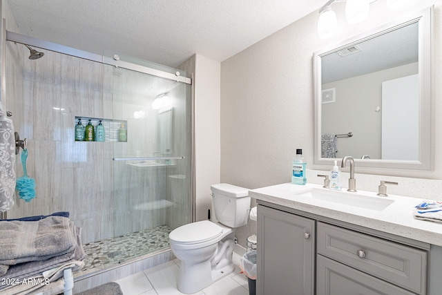 bathroom featuring walk in shower, tile patterned flooring, vanity, and toilet