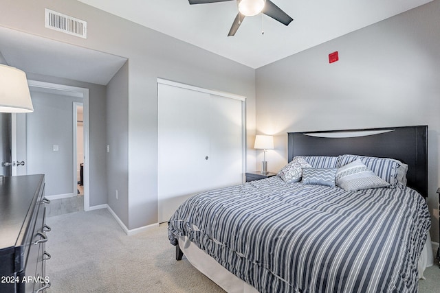 bedroom featuring light carpet, lofted ceiling, and ceiling fan