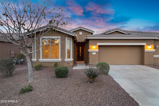 ranch-style home with a tiled roof, stucco siding, driveway, and a garage