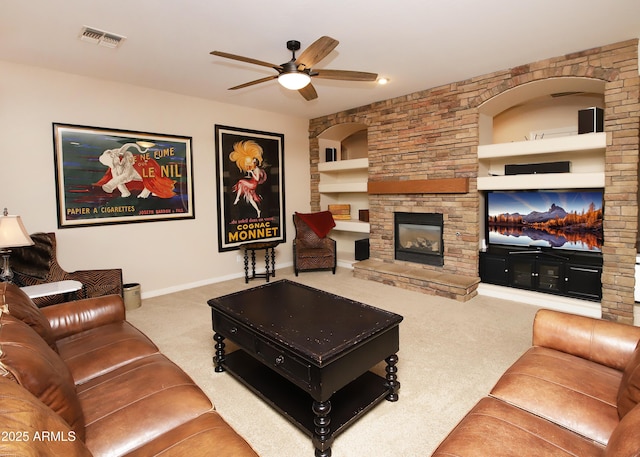 living area with built in shelves, a fireplace, carpet flooring, visible vents, and baseboards