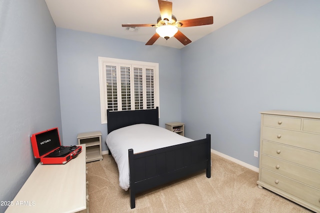 bedroom with visible vents, baseboards, a ceiling fan, and light colored carpet