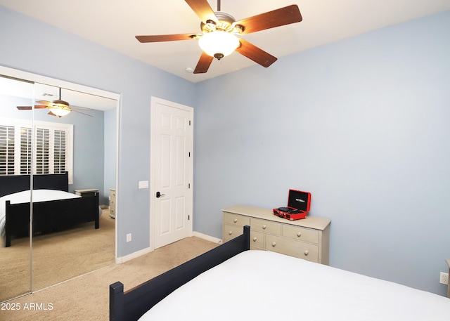 bedroom featuring a closet, light carpet, ceiling fan, and baseboards