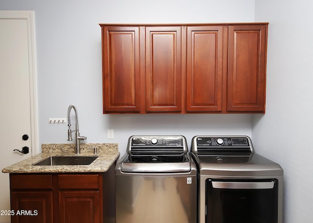 laundry area with washer and dryer, cabinet space, and a sink