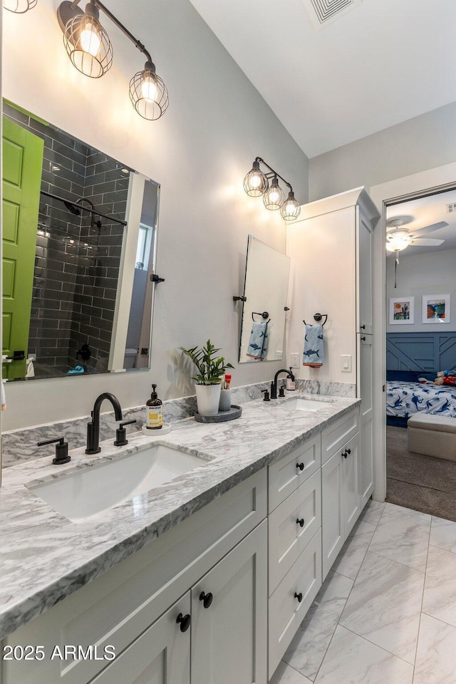 4132 N 42nd St, Phoenix, AZ 85018 - full bathroom featuring double vanity, ensuite bath, marble finish floors, a tile shower, and ceiling fan