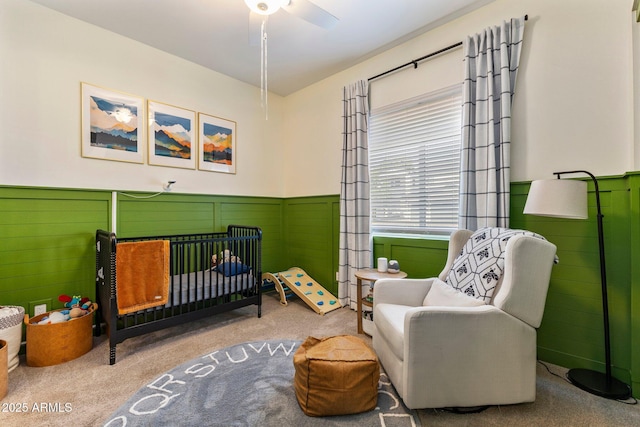 4132 N 42nd St, Phoenix, AZ 85018 - carpeted bedroom with a crib, wainscoting, and a ceiling fan