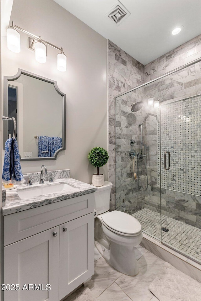 4132 N 42nd St, Phoenix, AZ 85018 - bathroom featuring marble finish floors, vanity, toilet, a shower stall, and recessed lighting