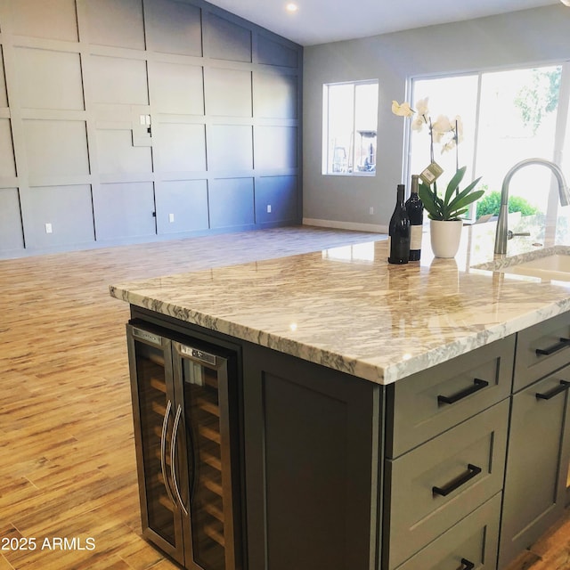 4132 N 42nd St, Phoenix, AZ 85018 - kitchen with beverage cooler, open floor plan, light stone countertops, light wood-style floors, and recessed lighting