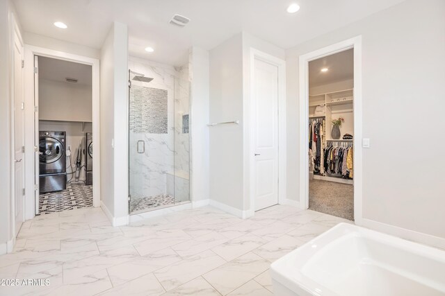 24314 N 21st Pl, Phoenix, AZ 85024 - full bathroom with separate washer and dryer, marble look tiles, a marble finish shower, baseboards, and a walk in closet