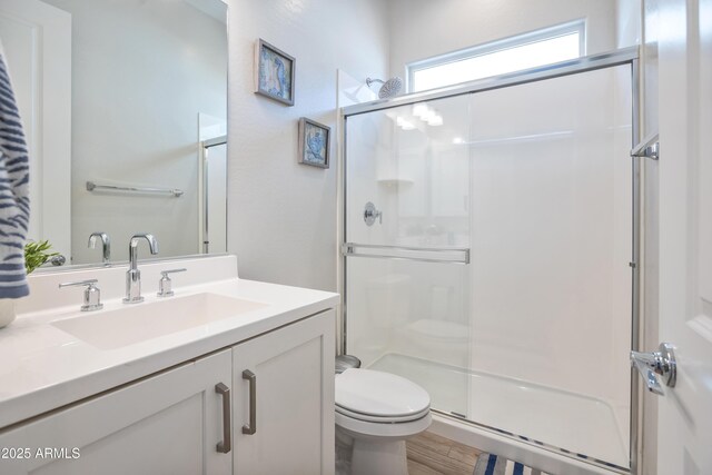 24314 N 21st Pl, Phoenix, AZ 85024 - bathroom with a stall shower, toilet, vanity, and wood finished floors