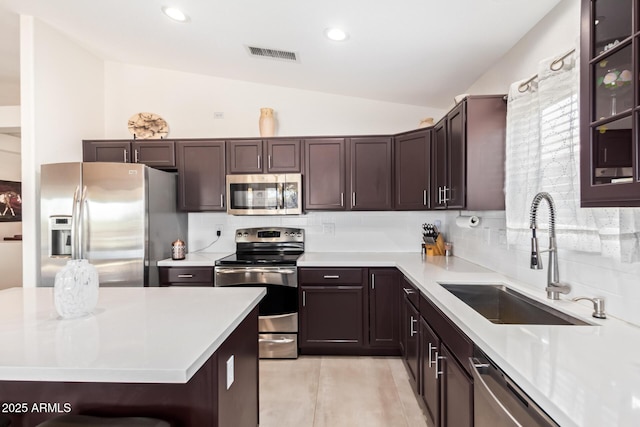 kitchen with a sink, stainless steel appliances, and light countertops