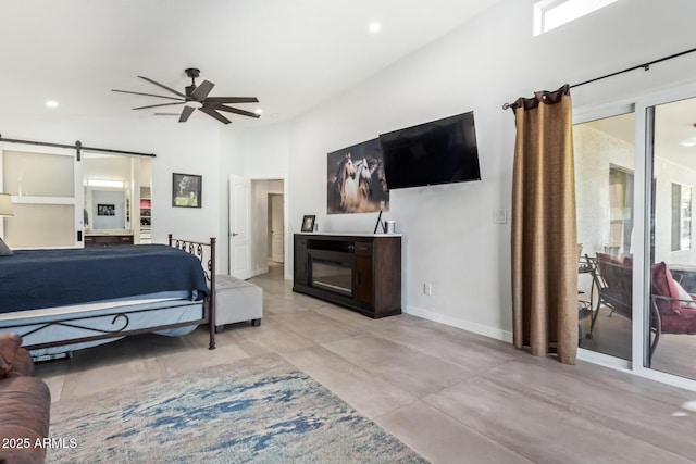 bedroom featuring a ceiling fan, recessed lighting, baseboards, and a barn door