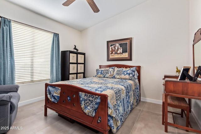 bedroom with a ceiling fan, vaulted ceiling, and baseboards