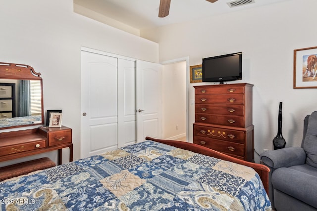 bedroom with ceiling fan, visible vents, and a closet